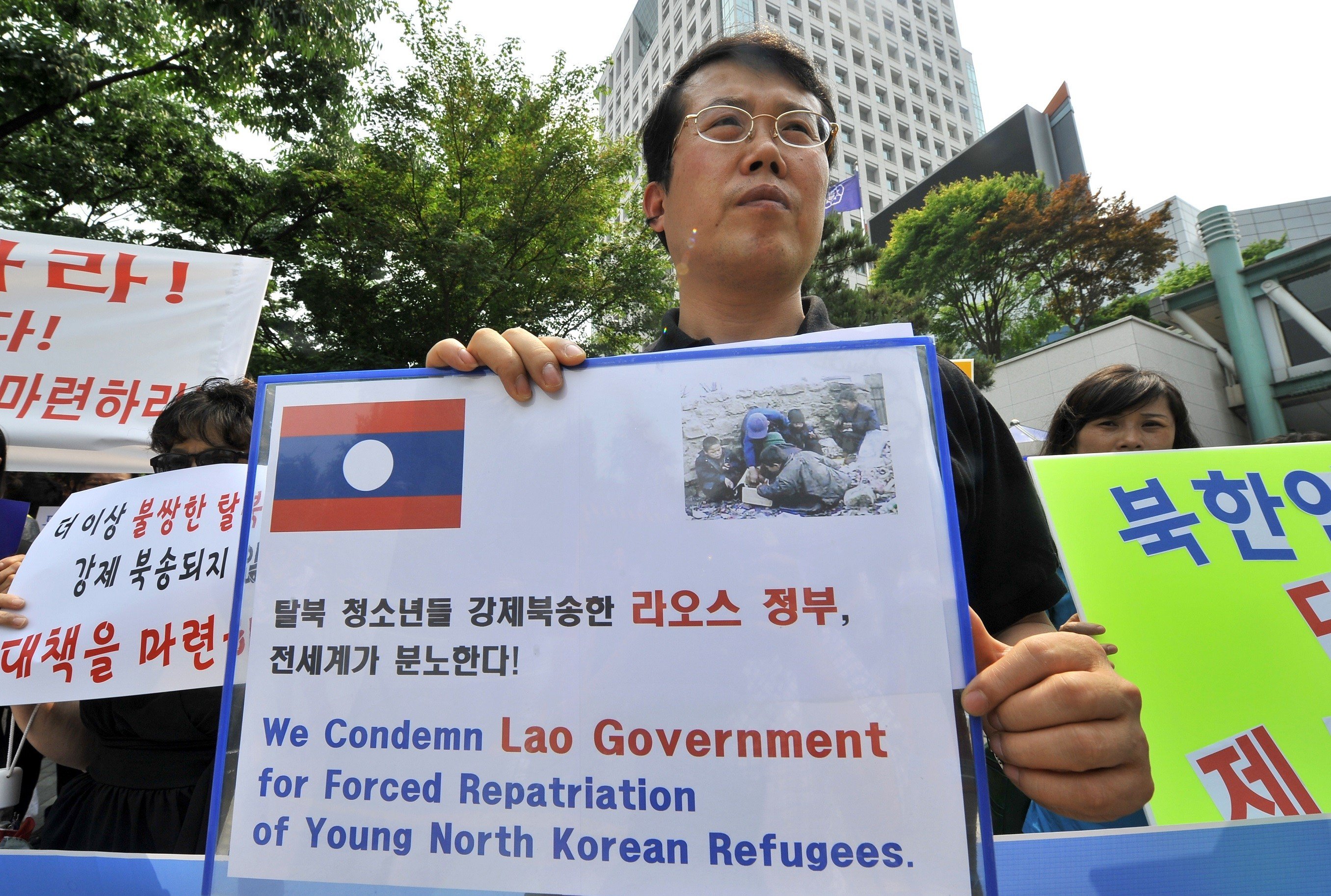 North Korea Defector protesting with sign
