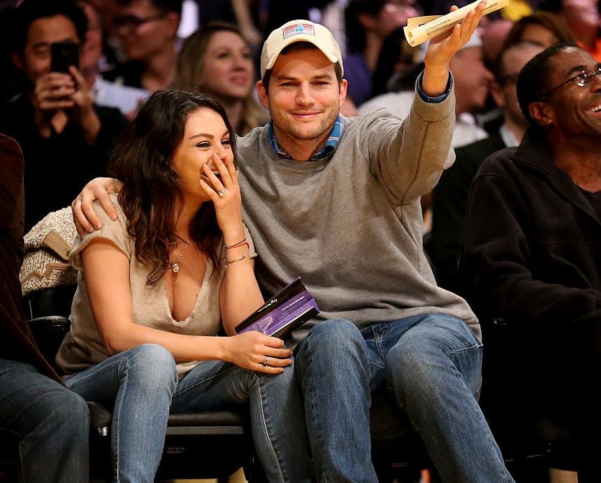 Mila Kunis and Ashton Kutcher Actors Ashton Kucher and Mila Kunis react after being shown on the video board