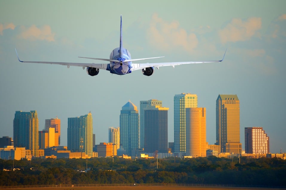 Tampa, Florida, skyline with warm sunset light with a commercial passenger jet airline