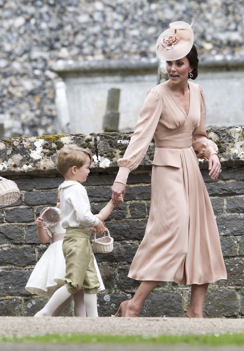 Kate Middleton holds her children at Pippa Middleton's wedding. 
