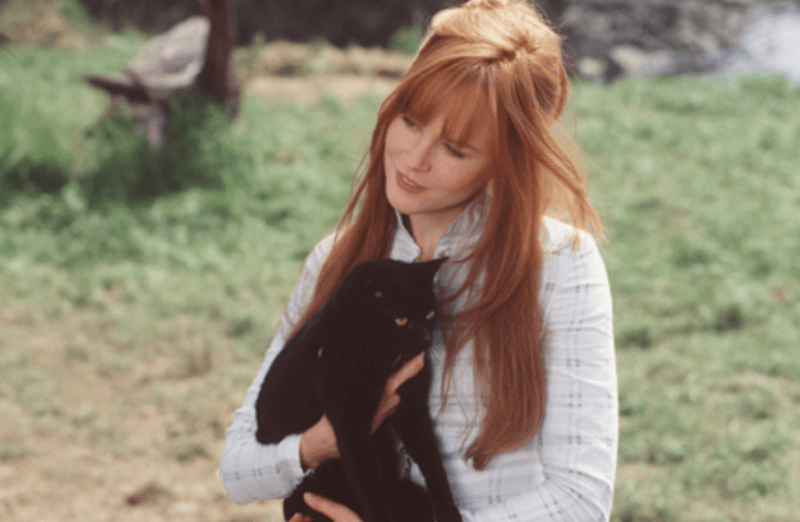 Gillian holding a black cat.