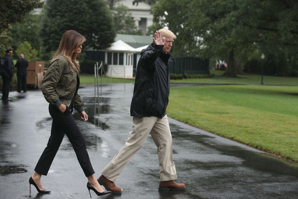 President Donald Trump walks with first lady Melania Trump prior to their Marine One departure
