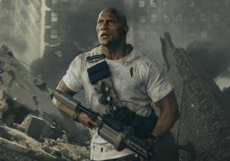 Dwayne Johnson holding a weapon in ' Rampage'.