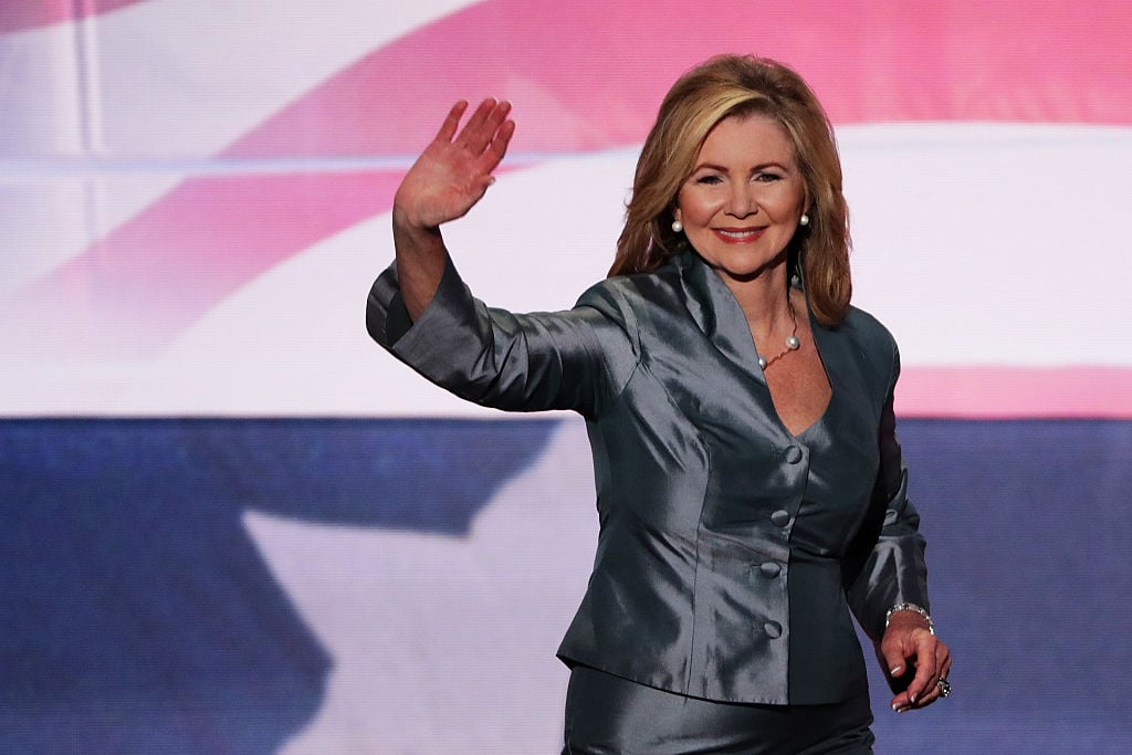 Rep. Marsha Blackburn waves to the crowd as she walks on stage to deliver a speech