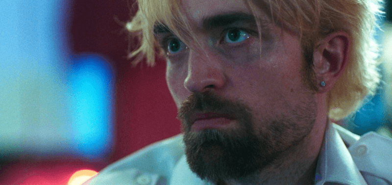 Robert Pattison staring straight ahead in shock in 'Good Time'. 