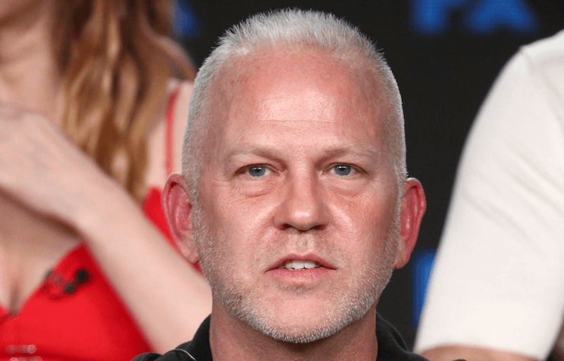 Ryan Murphy sitting on stage during a panel presentation. Ryan Murphy sitting on stage during a panel presentation.