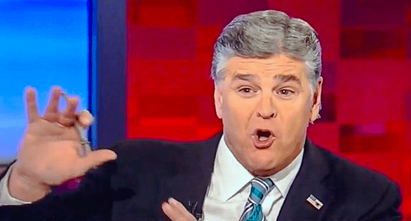 Sean Hannity raises his hands in a defensive motion