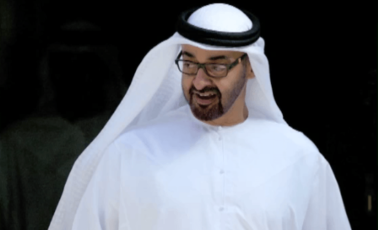Sheik Mohammed Bin Zayed Al Nahyan stands while greeting guests at an event. Sheik Mohammed Bin Zayed Al Nahyan stands while greeting guests at an event.