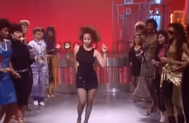 Soul Train dancer performing in front of a crowd. 