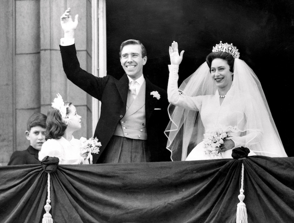 The newly-wed Princess Margaret, the younger sister of Britain's Queen Elizabeth II, and her husband, the photographer Antony Armstrong-Jones wave