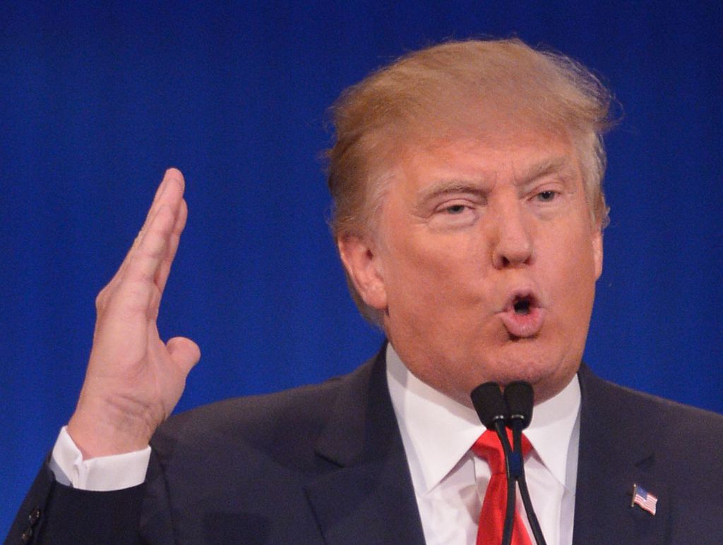 Donald Trump making a slicing motion at Republican debate