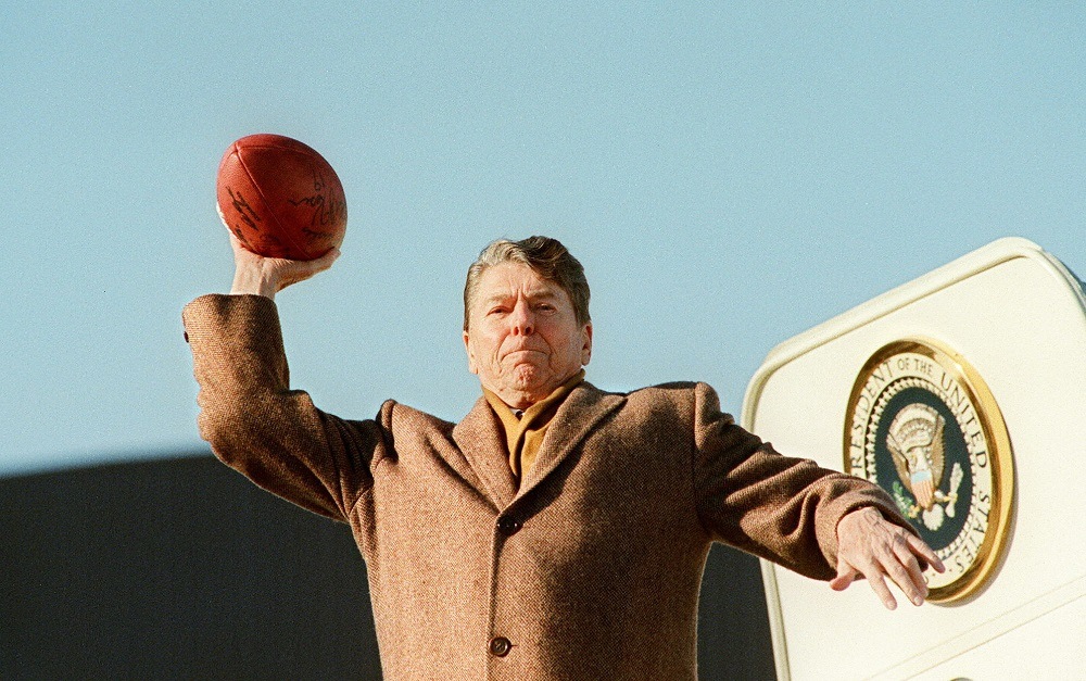 U.S. President Ronald Reagan throws a football