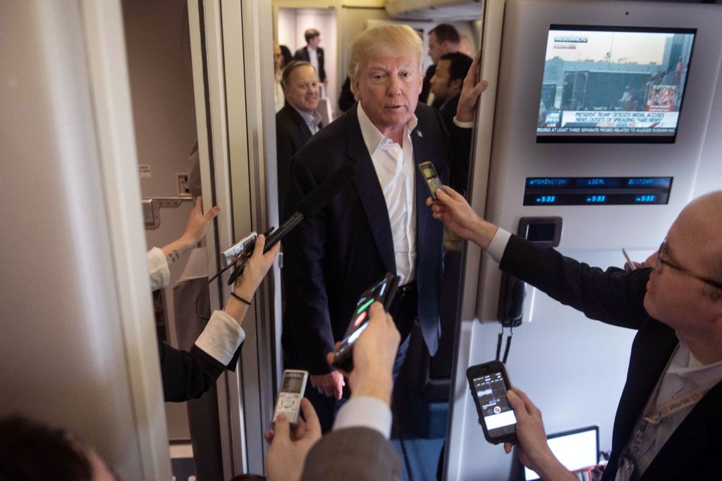 US President Donald Trump speaks to the press aboard Air Force One