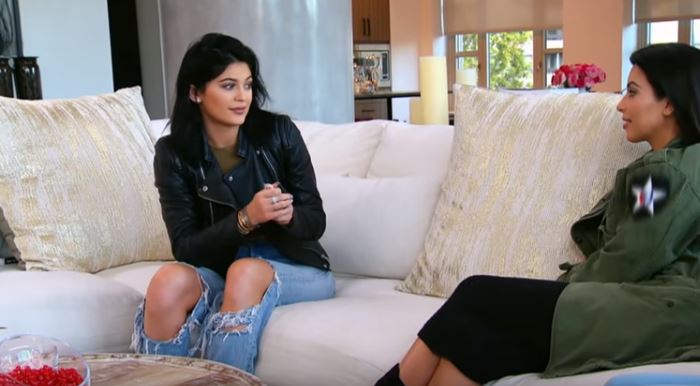 Kylie Jenner and Kim Kardashian sitting on a couch on Keeping Up with the Kardashians