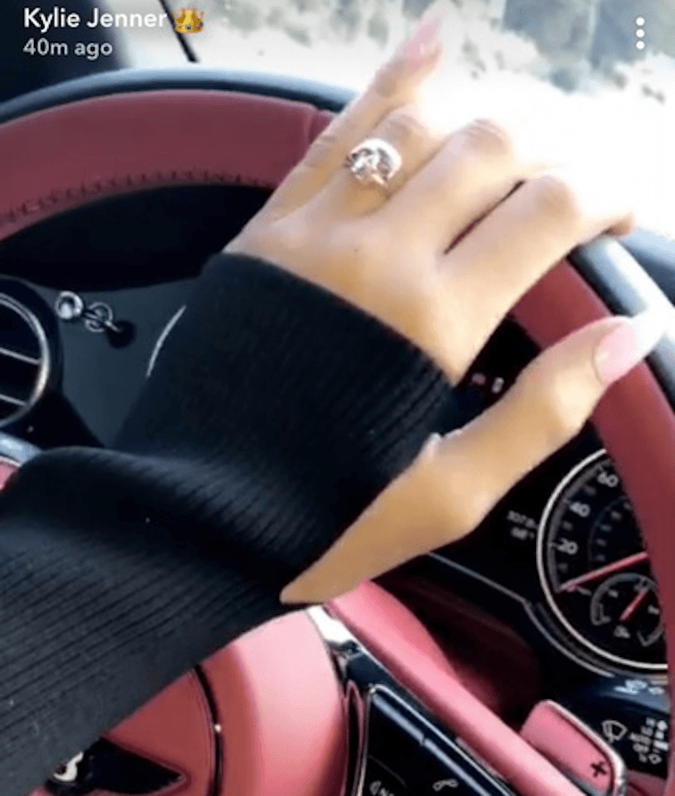 Kylie Jenner's hand on a pink steering wheel Kylie Jenner's hand on a pink steering wheel