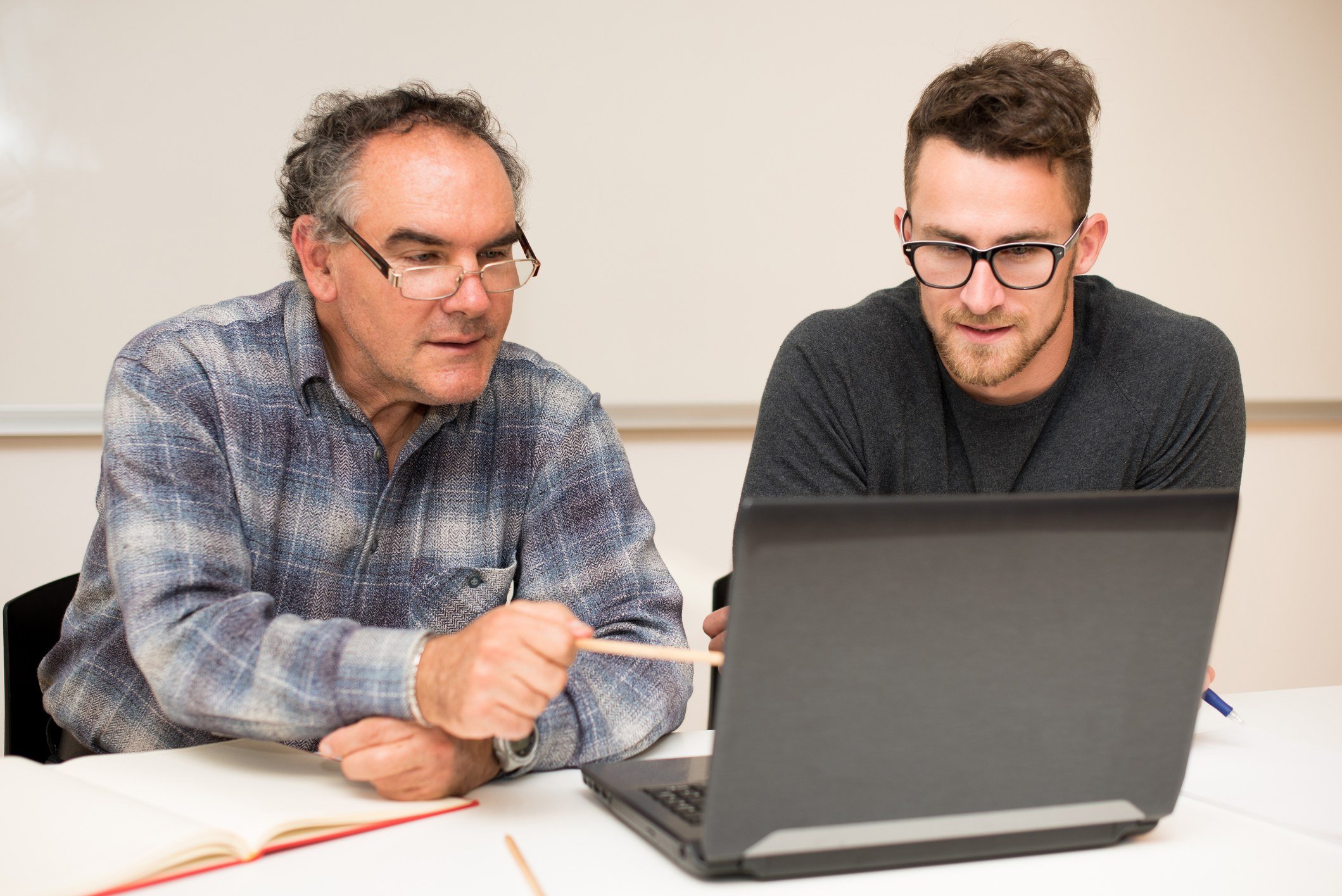 Tutor teaching young man