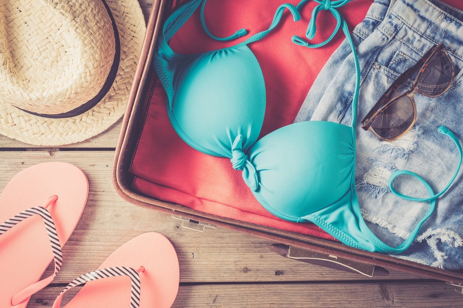 Packing suitcase with swimsuit