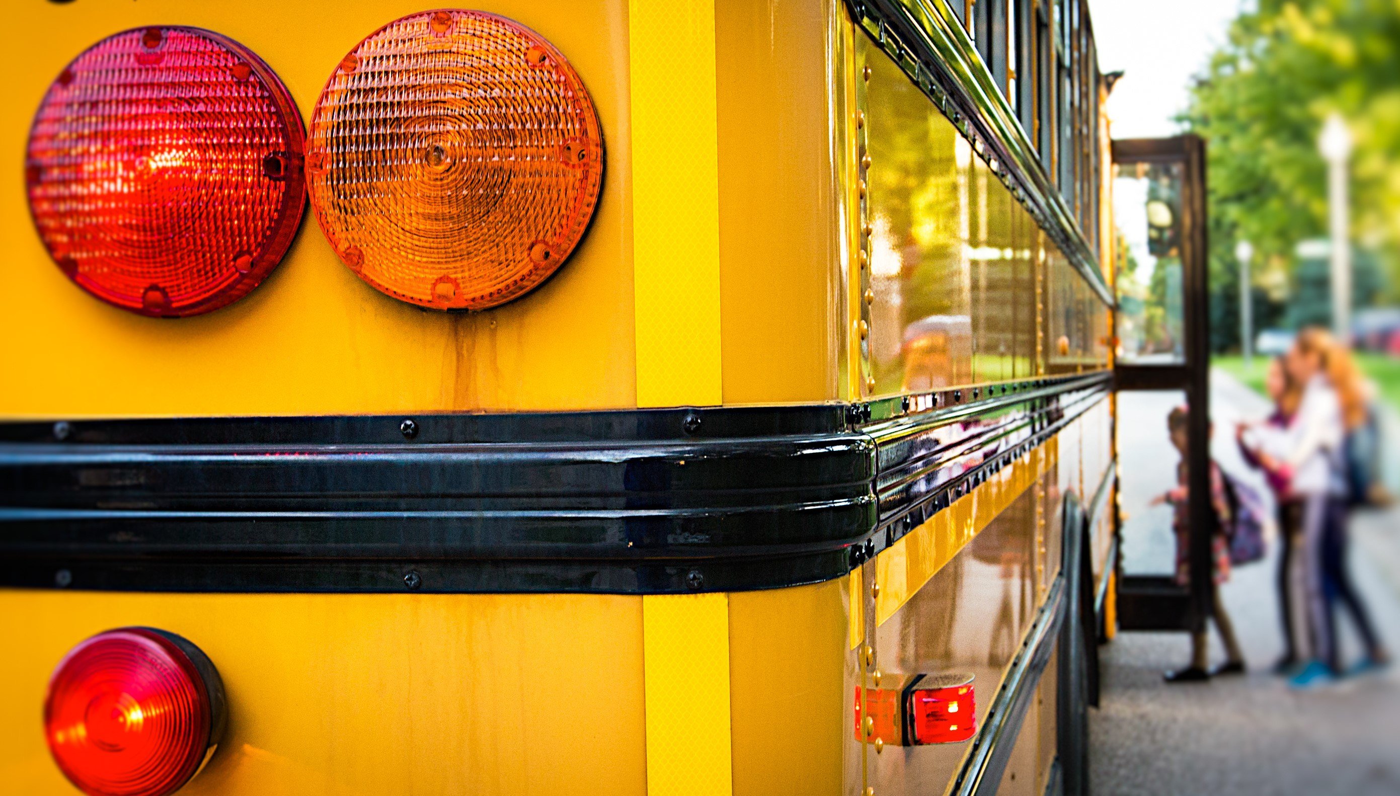 Yellow School Bus from the back as children get in