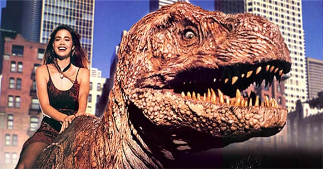 Denise Richards sits on top of a dinosaur Denise Richards sits on top of a dinosaur