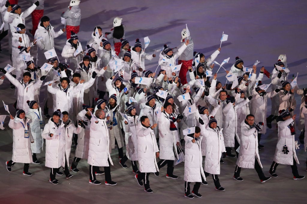 The North Korea and South Korea Olympic teams enter together under the Korean Unification Flag