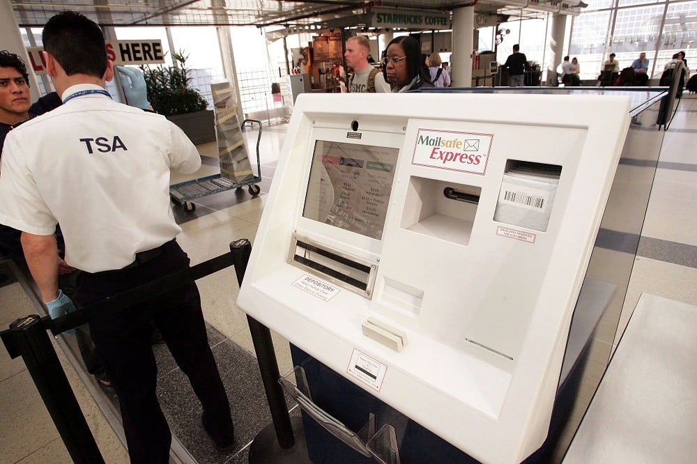 A TSA employee speaks with a passenger at O'Hare Airport