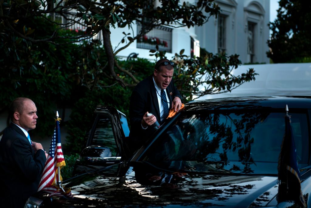 A member of the Secret Service cleans one of US President Donald Trump's armored limousines