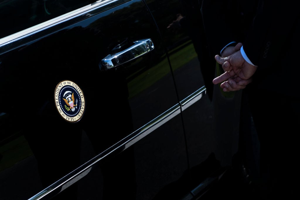 A member of the Secret Service stands with US President Donald Trump