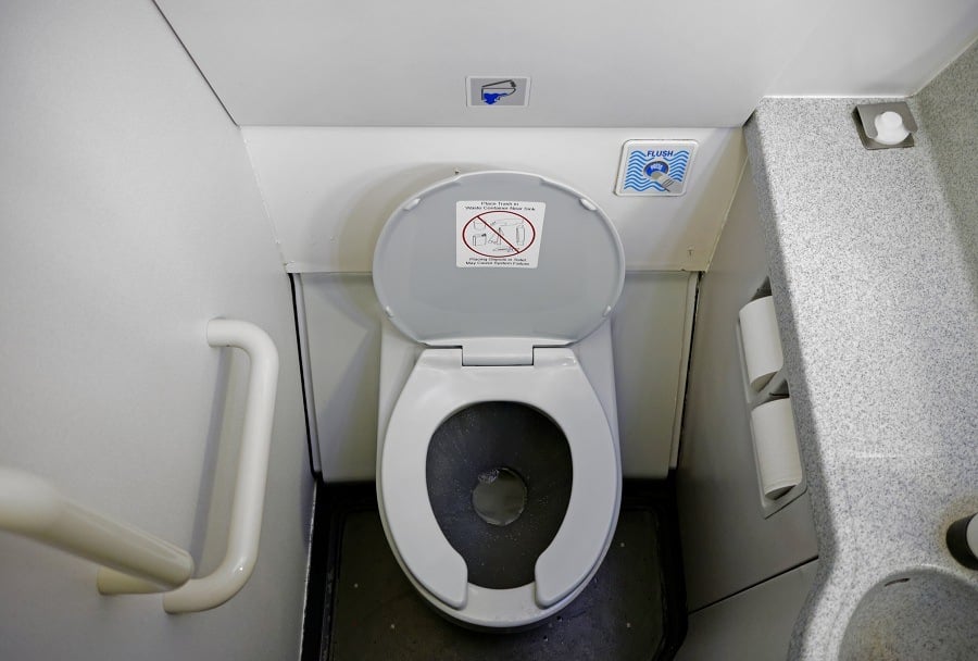 dirty bathroom of a commercial airliner