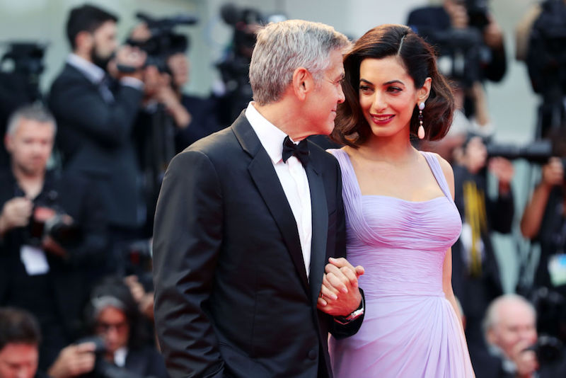 George Clooney holding hands with Amal. George Clooney holding hands with Amal.