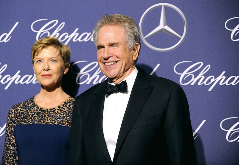 Annette Bening and Warren Beatty smiling in front of a blue backdrop. Annette Bening and Warren Beatty smiling in front of a blue backdrop.