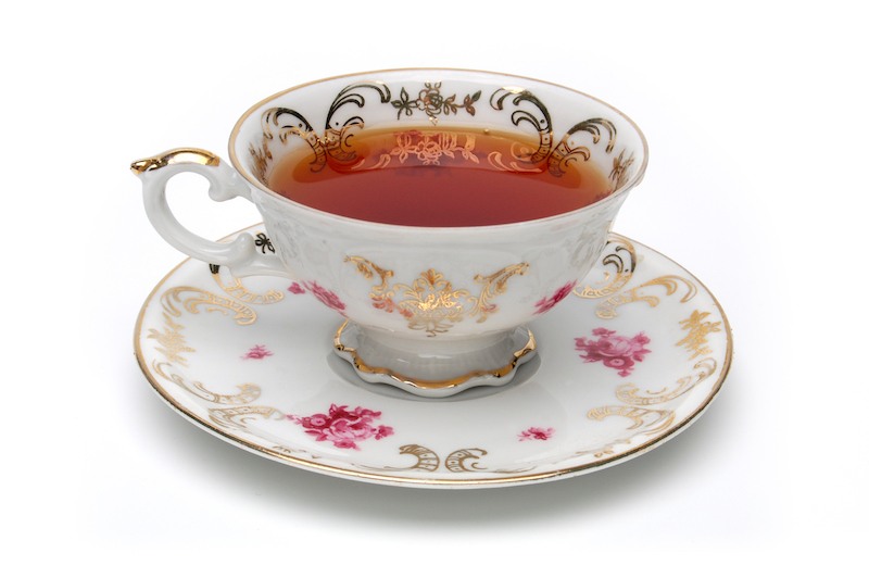An antique tea cup on a white background. An antique tea cup on a white background.