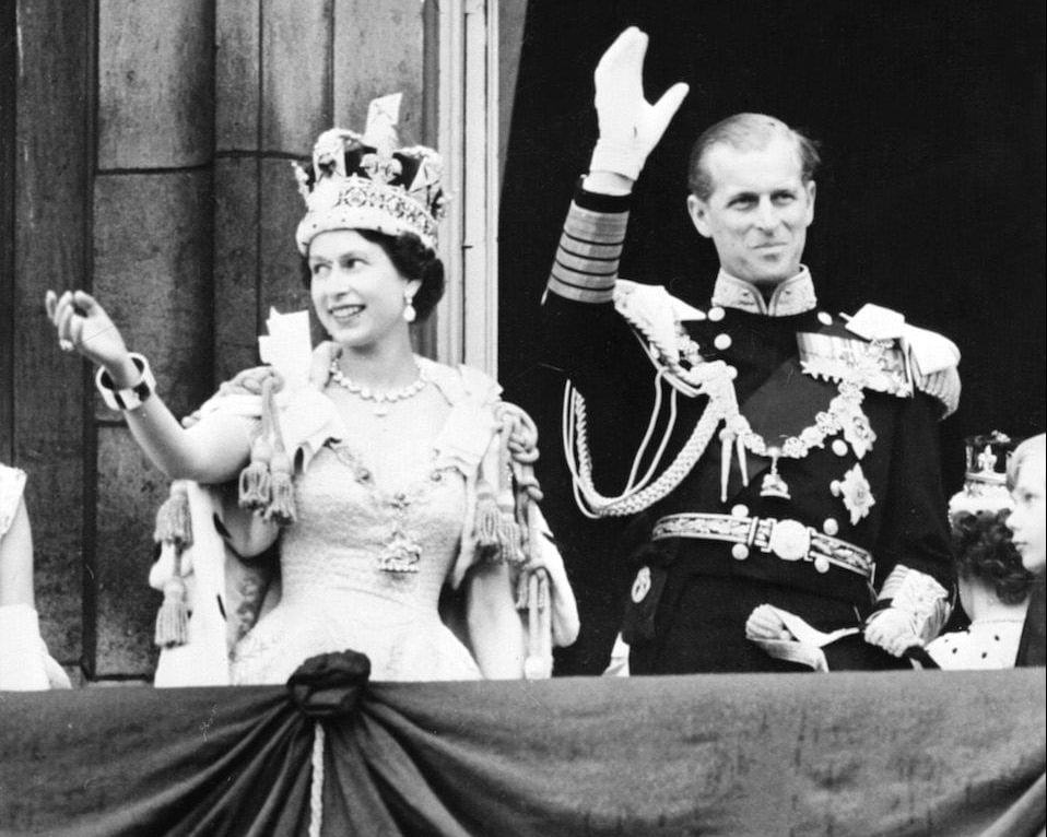 Queen Elizabeth II accompanied by Prince Philip waves to the crowd after being crowned solemnly at Westminter Abbey in London