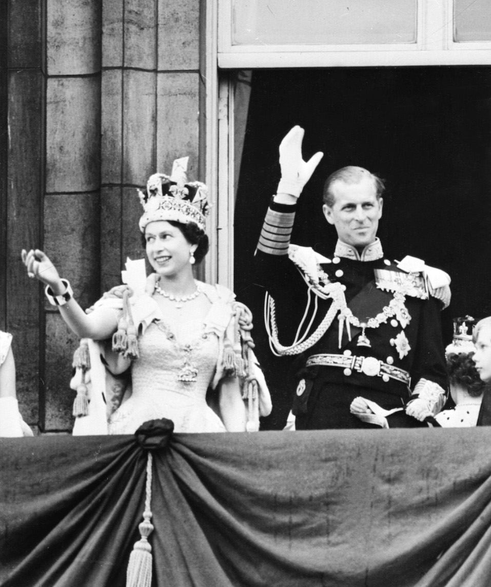 Queen Elizabeth II accompanied by Prince Philip waves to the crowd after being crowned solemnly at Westminter Abbey in London