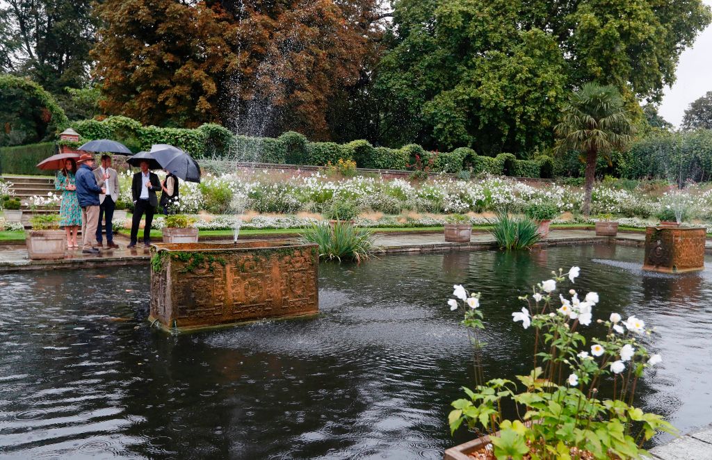 Britain's Prince William, Duke of Cambridge his wife Britain's Catherine, Duchess of Cambridge and his brother Britain's Prince Harry havea attended an event at the memorial gardens in Kensington Palace