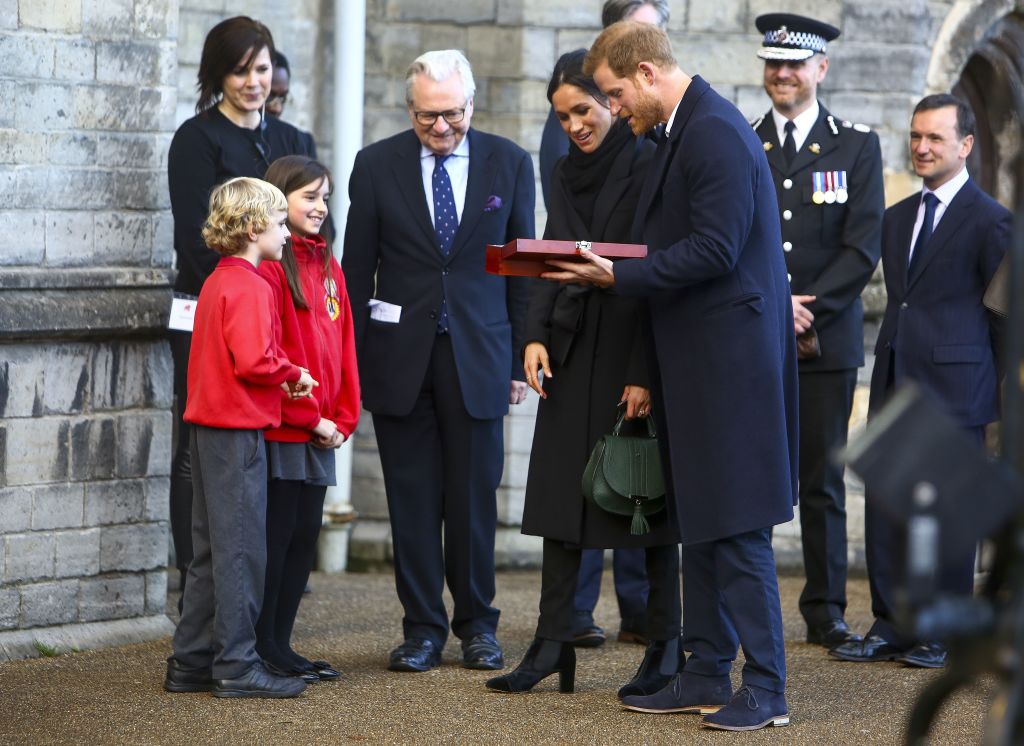 Harry Smith and Megan Taylor, both from Marlborough Primary School, present a wedding gift to Britain's Prince Harry and his fiancée US actress Meghan Markle on their arrival at Cardiff Castle in Cardiff,