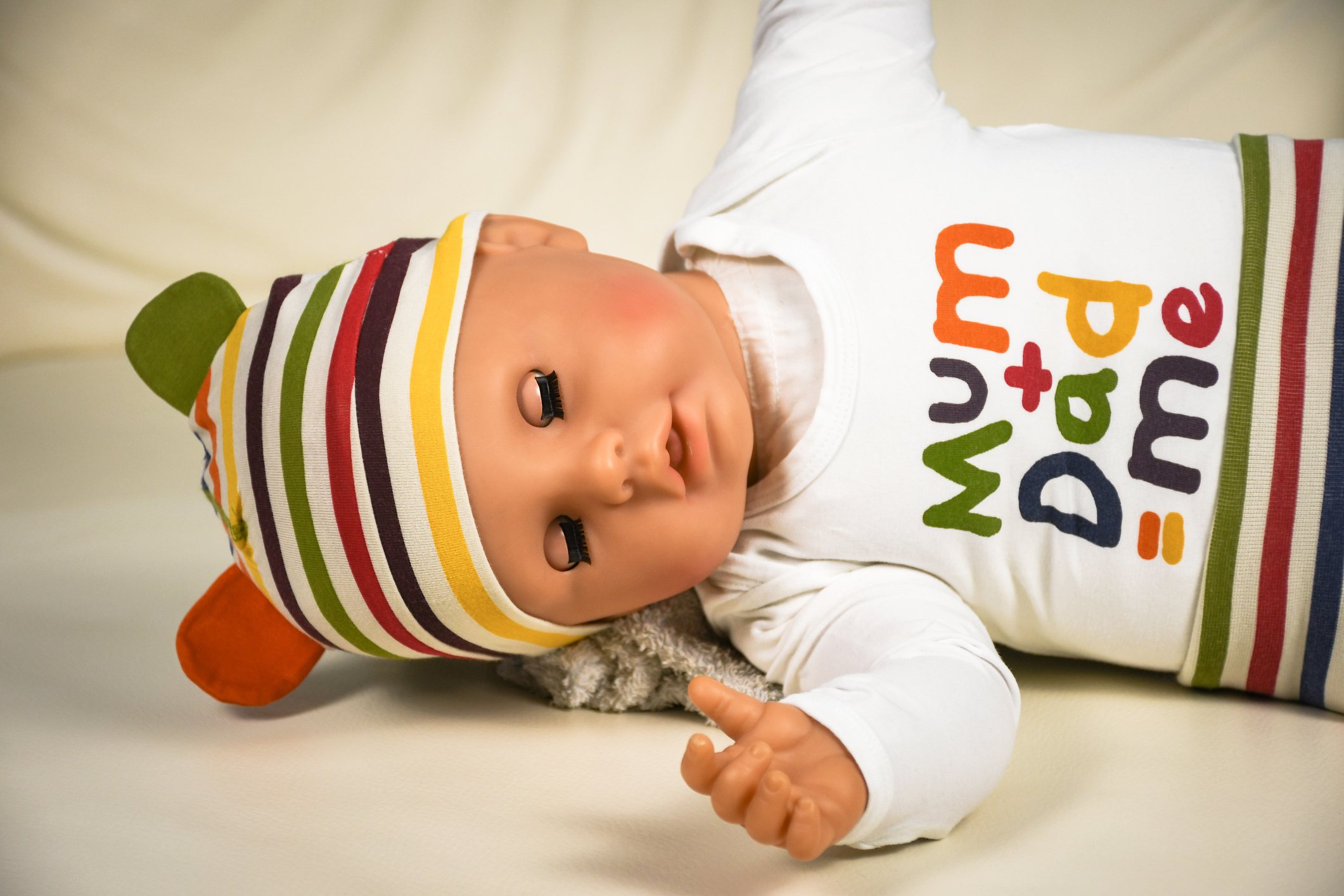Plastic baby doll lying on a couch