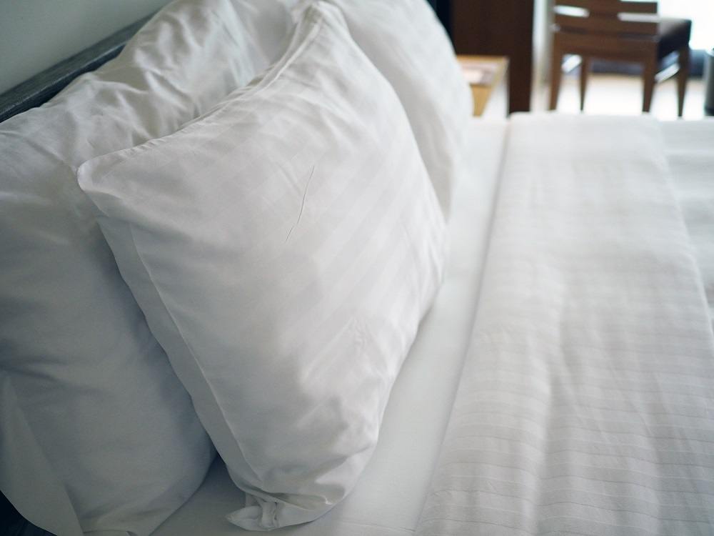 Big white soft pillows on a white luxury cozy bed