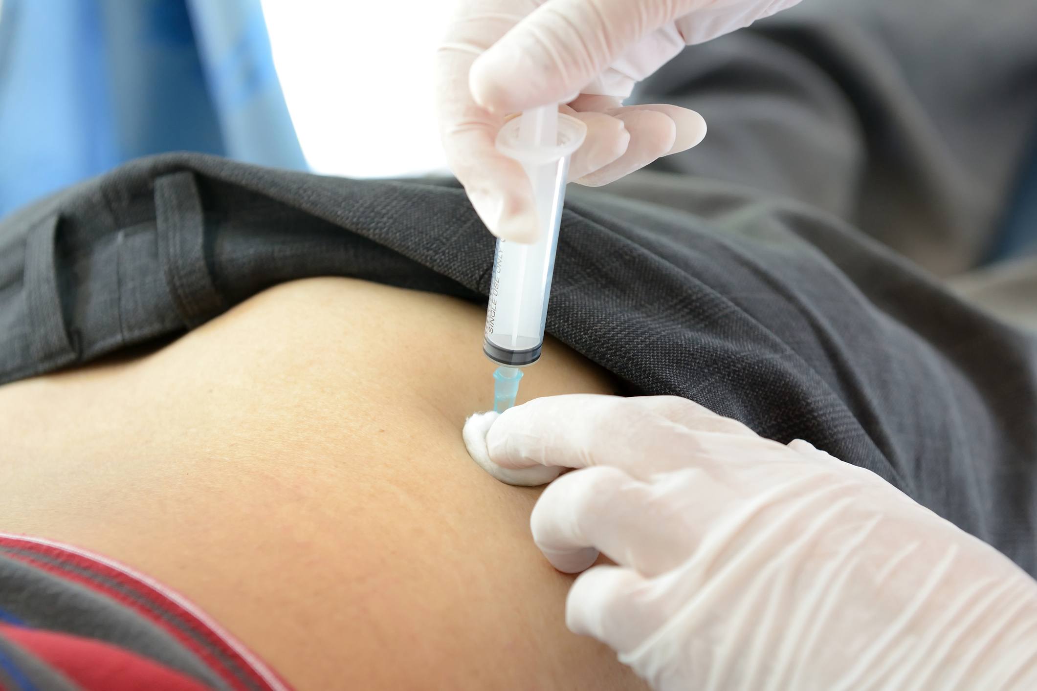 Injection syringe with medicine on the buttock