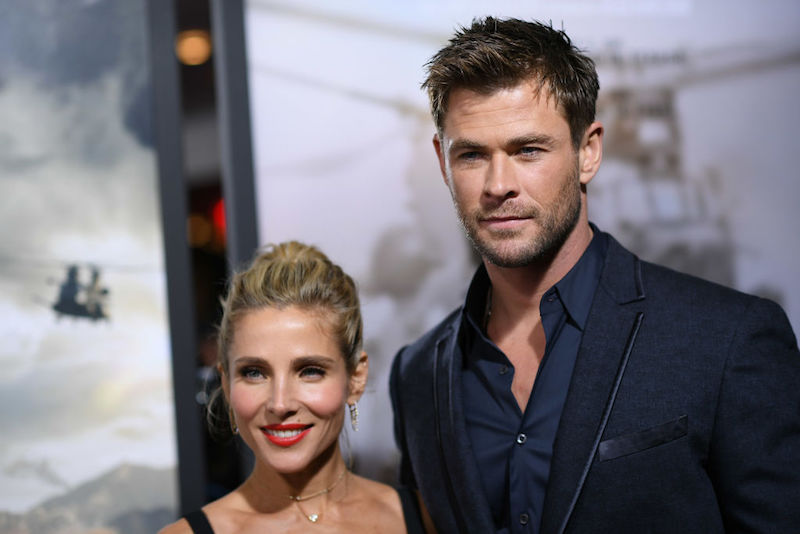 Chris Hemsworth and Elsa Pataky posing for photographers on a red carpet.