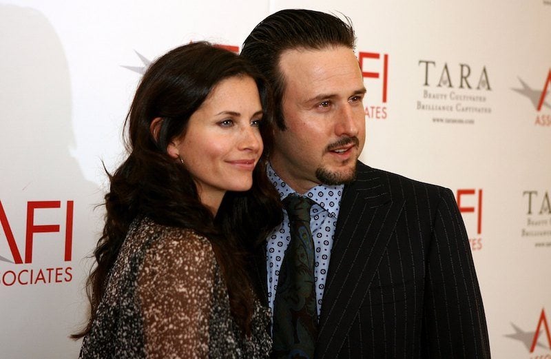Courteney Cox and David Arquette standing closely together as they pose for photos on a red carpet. 
