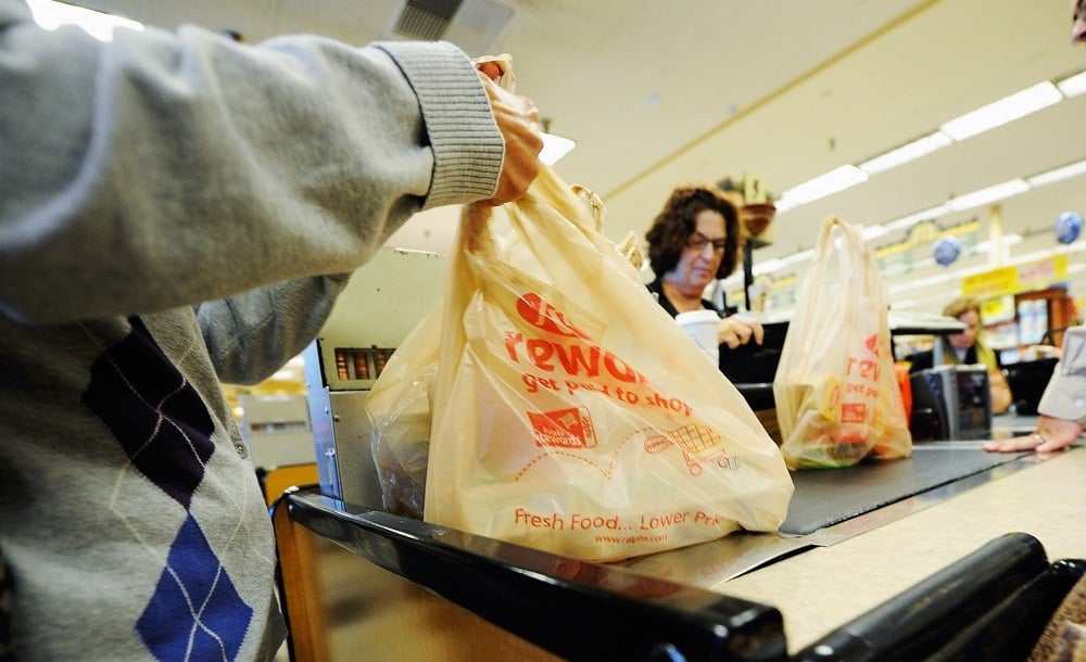 Customers of Ralphs supermarket use plastic bags
