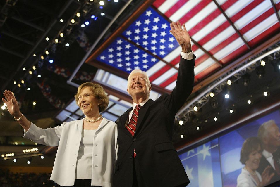 Former U.S. President Jimmy Carter and his wife Rosalynn wave to the audience during the Democratic National Convention