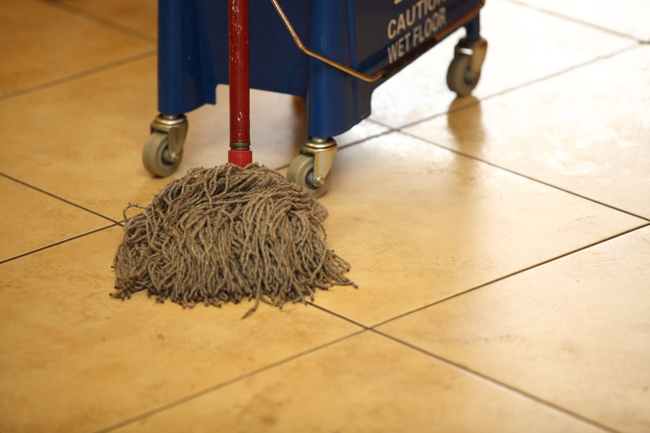 cleaning the floor with a old mop, mopping