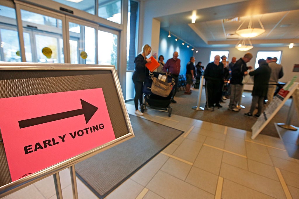 People stand in line to vote on the first day of early voting at the Provo Recreation Center, on October 25, 2016 in Provo, Utah