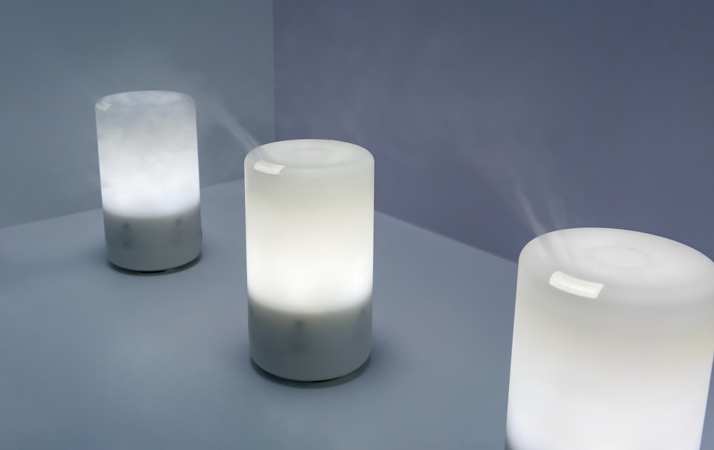 Electric aroma oil diffuser on wooden floor
