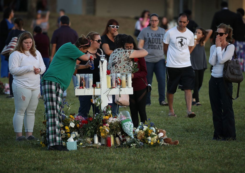 People visit a memorial at Pine Trails Park on February 17, 2018 in Parkland, Florida