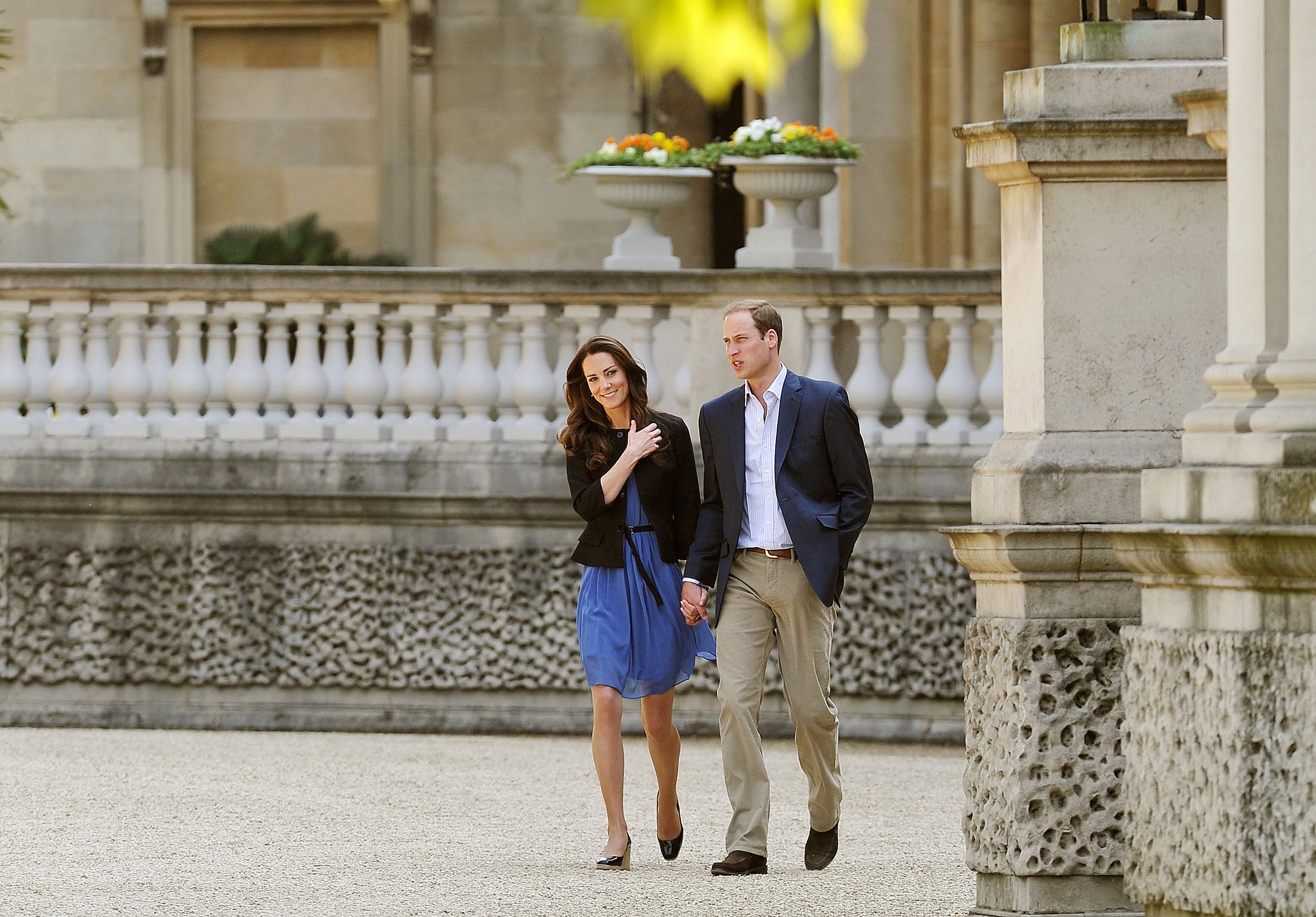 Prince William, Duke of Cambridge and Catherine, Duchess of Cambridge walk hand in hand from Buckingham Palace
