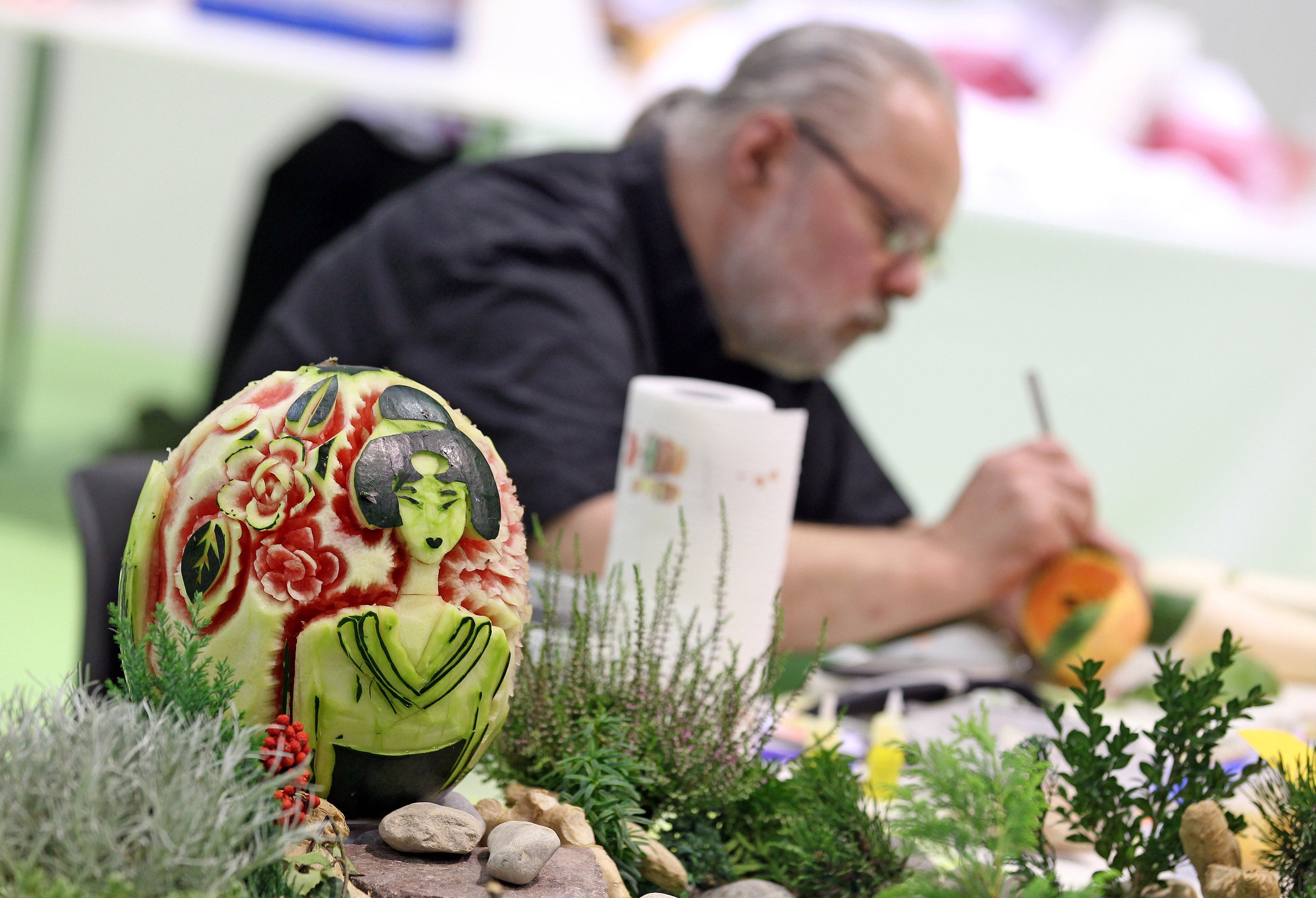 a german artist demonstrates fruit carving with a melon a german artist demonstrates fruit carving with a melon