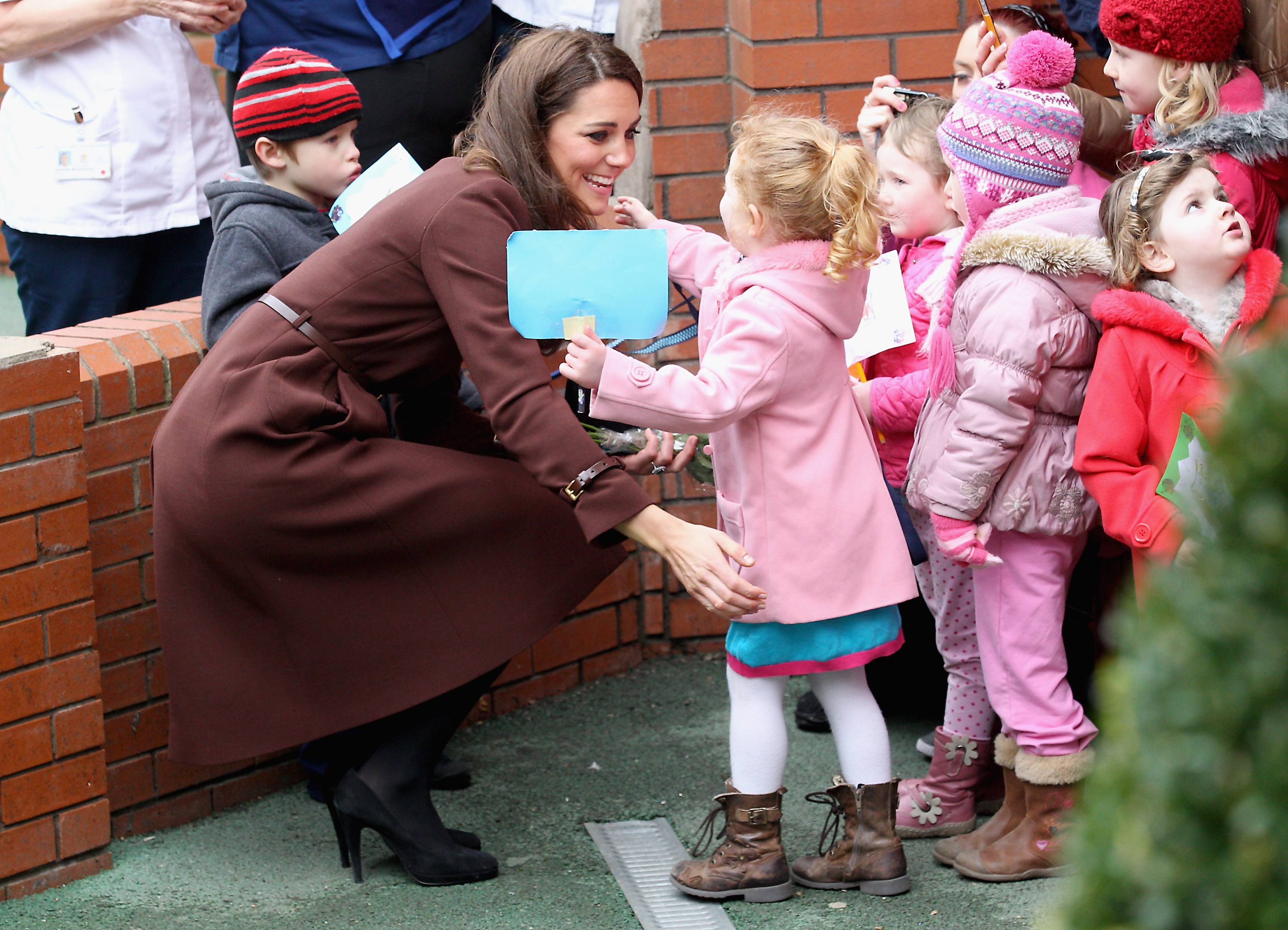 Catherine, Duchess of Cambridge hugs a young girl as she visits Alder Hey Children's NHS Foundation Trust on February 14, 2012 in Liverpool, England. The Duchess has spent the day in Liverpool and arrived at Alder Hey Hospital after a visit to 'The Brink'.