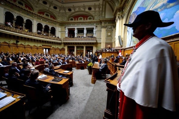 A Swiss usher stands in the Parliament room of the Swiss Federal Assembly.